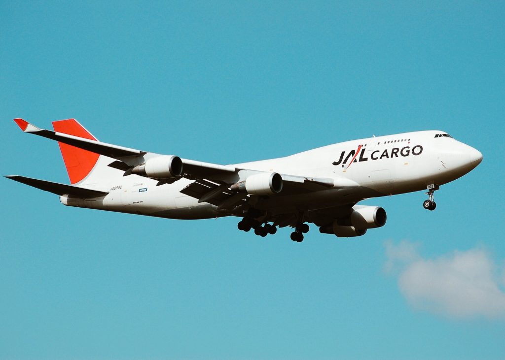 Japan Air Lines Cargo Plane in Air with Blue Sky